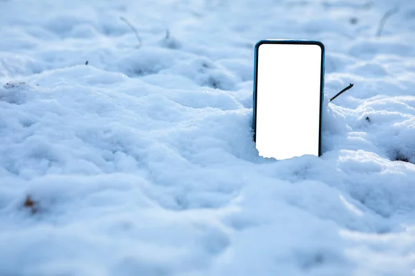 phone in snow white empty screen copy space