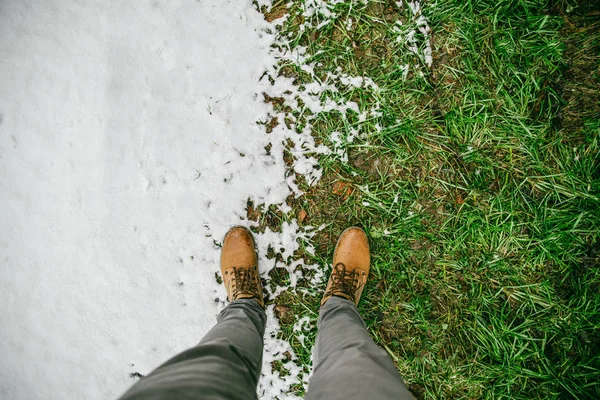 Homme se tiennent en place où l'hiver rencontre le printemps — Photo