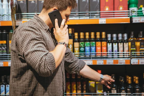 man talking on phone in grocery store need assistance in shopping list copy space