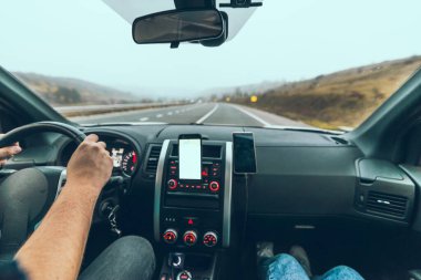 car travel concept autumn highway phone with white screen on dashboard copy space