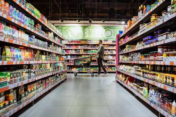 Hombre Joven Con Carrito Compras Entre Tienda Comestibles —  Fotos de Stock
