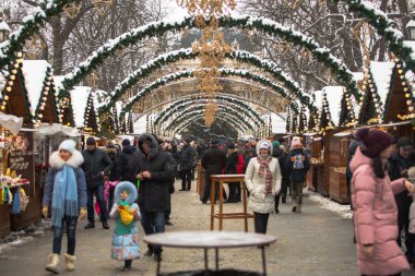 Lviv, Ukraine - 4 January, 2019: people walking by christmas fair having fun