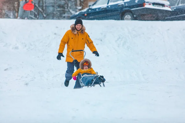 Vater Mit Tochter Gelben Wintermänteln Rutscht Verschneiten Hügel Familienzeit — Stockfoto