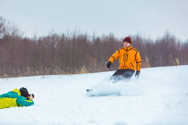 Ember Feküdt Földön Fényképez Snowboardos Megáll Mellette — Stock Fotó