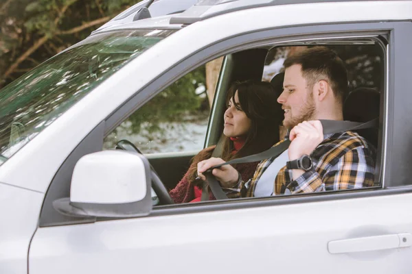 couple inside rent car talking ready for road trip