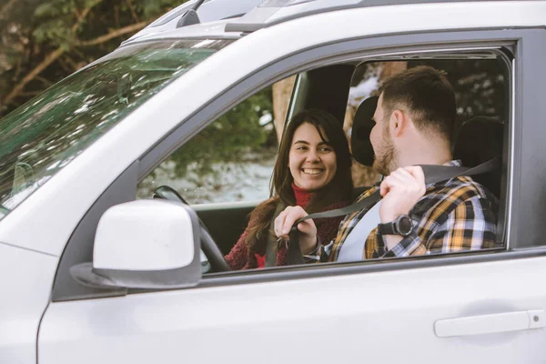 couple inside rent car talking ready for road trip