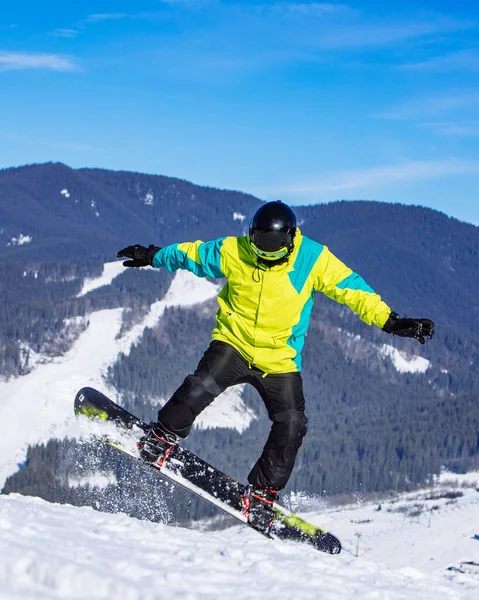 Man Green Coat Jumping Snowboard Winter Mountains Travel — Stock Photo, Image