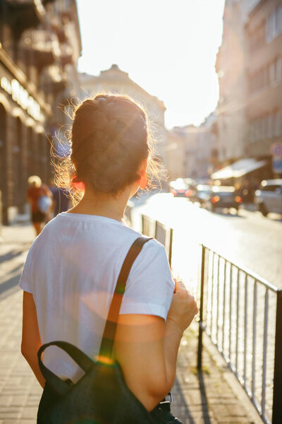 portrait of pretty woman on sunset at city street urban outfit