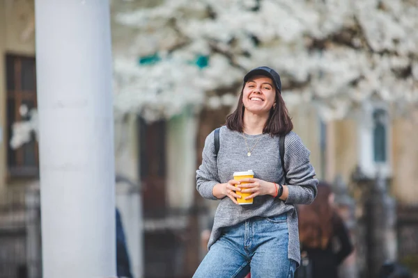 Young Stylish Woman Walking Street Coffee Cup Spring Blooming Tree — 스톡 사진