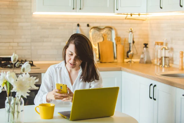 Young Pretty Caucasian Woman Talking Phone Sitting Front Laptop Kitchen — Stock Photo, Image