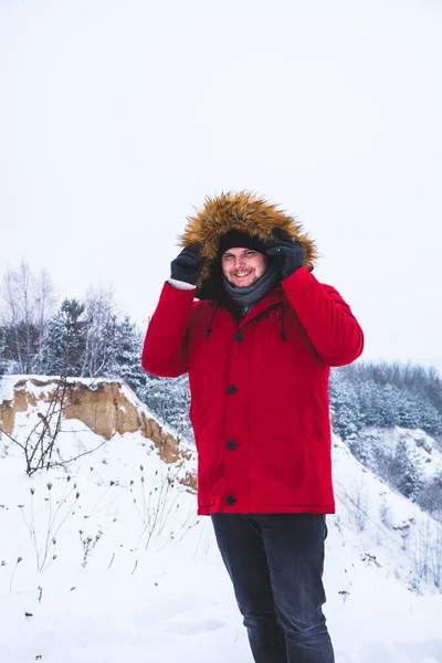 Smiling Young Man Red Winter Coat Fur Hood Snowed Field — Stock Photo, Image