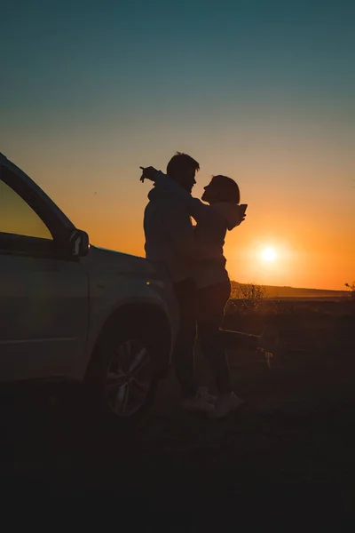 romantic moment couple kissing on sunset near white suv car copy space.