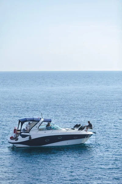 small motor speed boat in sea water with men. summer vacation