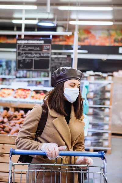 woman in medical mask do grocery shopping. copy space. coronavirus concept