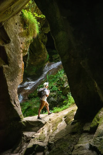 Young Adult Strong Man Backpack Cave Entrance Looking Sunlight Summer — Stock Photo, Image