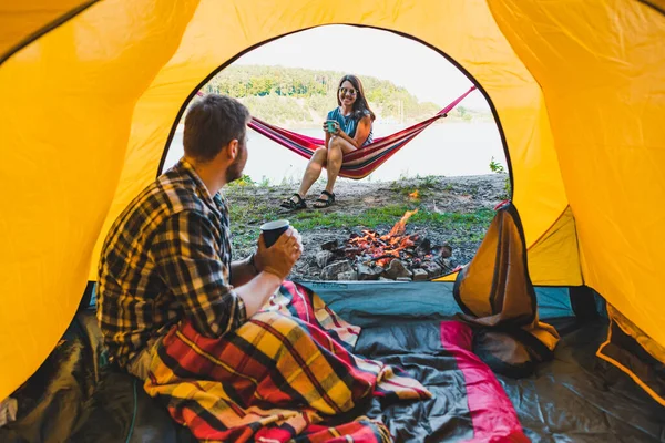 Couple Resting Fire Man Sitting Tent Woman Laying Hammock Camping — Stock Photo, Image