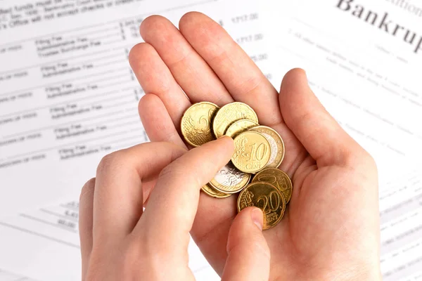 Person counts euro coins at documents background. Bankruptcy concept. — Stock Photo, Image