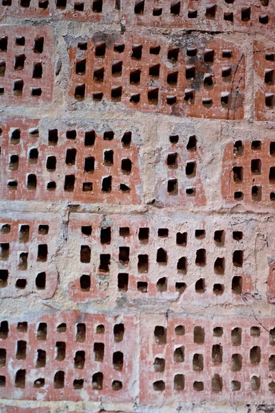 Big old red-orange brick wall background with little holes. Vint — Stock Photo, Image