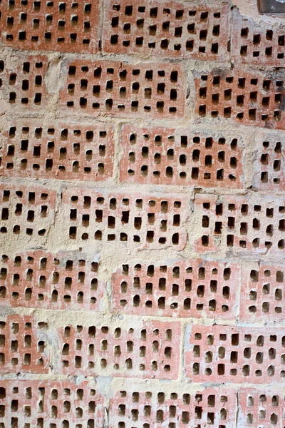 Fondo grande de la pared de ladrillo rojo-naranja con pequeños agujeros. Vint. —  Fotos de Stock