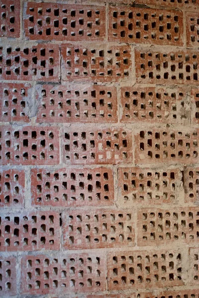 Big old red-orange brick wall background with little holes. Vint