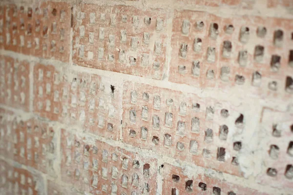 Big old red-orange brick wall background with little holes. Vint — 스톡 사진