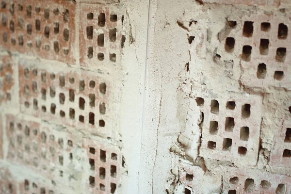 Big old red-orange brick wall background with little holes. Vint