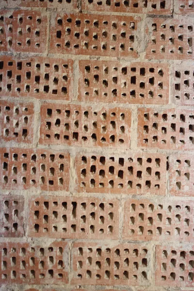 Big old red-orange brick wall background with little holes. Vint