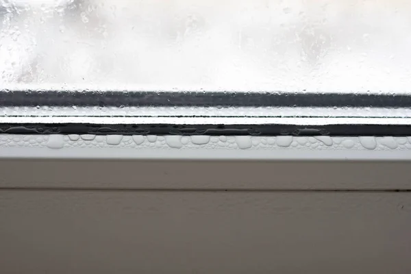 Transparent condensate on the foggy, plastic window, drops of wa