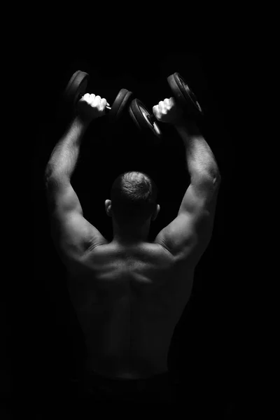 Man makes exercises with barbell. — Stock Photo, Image