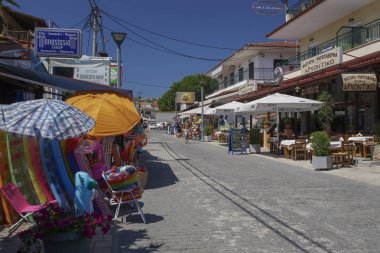 CHANIOTIS, GREECE - JULY 08 2017: Local shops on the town streets. clipart