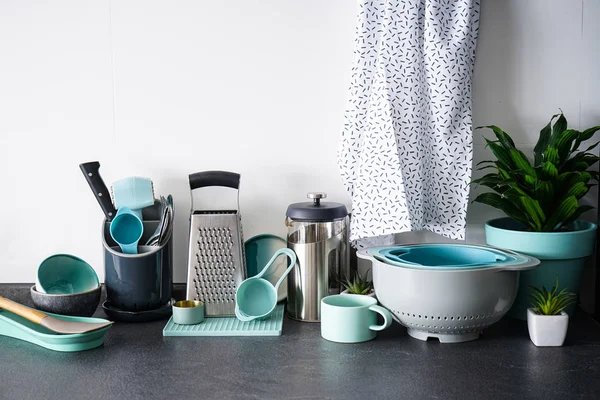 Set of dishes and kitchen utensils on a white background. Kitchen utensils on the background of the kitchen.