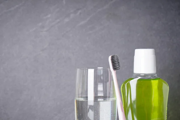 Toothbrush Mouthwash Glass Water Gray Background Close Place Text Dental — Stock Photo, Image