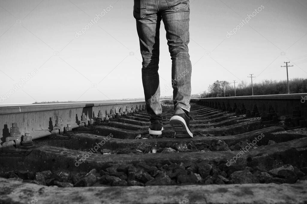 Young man going along railway track