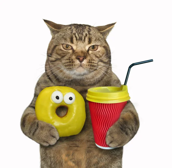 Cat with yellow donut and cappuccino Stock Picture