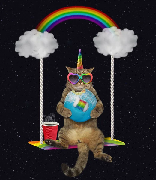 Caticorn eats blue donut on swing — ストック写真