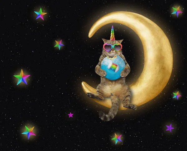 The cat unicorn in heart shaped sunglasses is eating a blue donut on the comfortable moon in space. Stars background.
