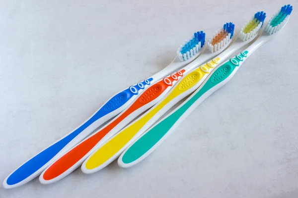 New colorful toothbrushes on a light background. The concept of oral hygiene. — Stock Photo, Image