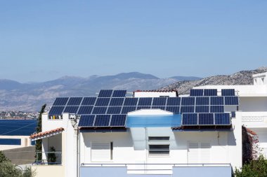 Yunanistan, deniz manzarası, çatıda güneş panelleri ile ev.