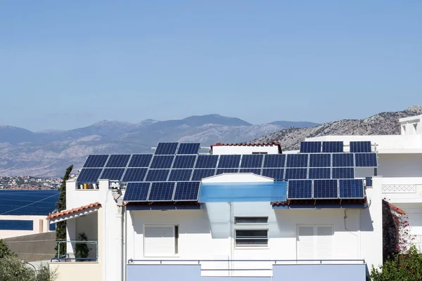 Greece, sea view, house with solar panels on the roof.