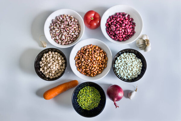 Set of products for making a recipe from legumes: phaseolus; beans; chickpeas; mung beans; tomatoes, onions, carrots, garlic and herbs.
