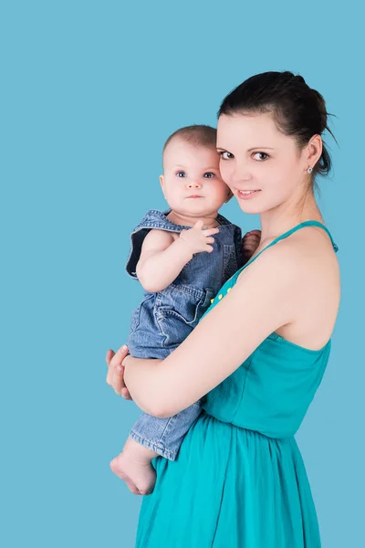 Feliz madre sosteniendo a su bebé, aislado en azul —  Fotos de Stock