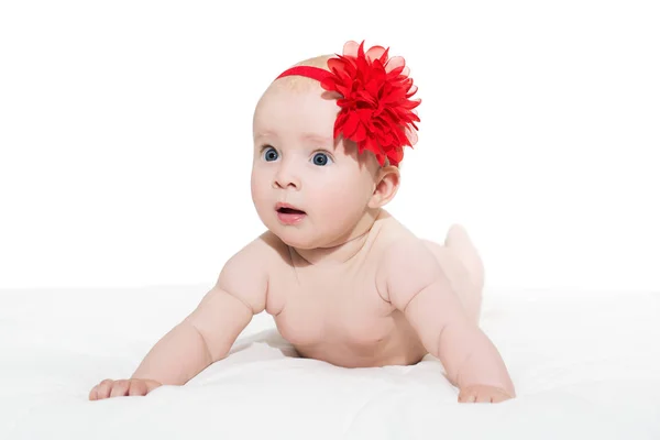 Portrait of cute little baby girl with red bow flower on her hea — Stock Photo, Image