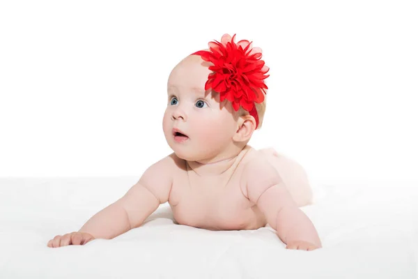 Cute little baby girl with red bow flower on her head Stock Photo