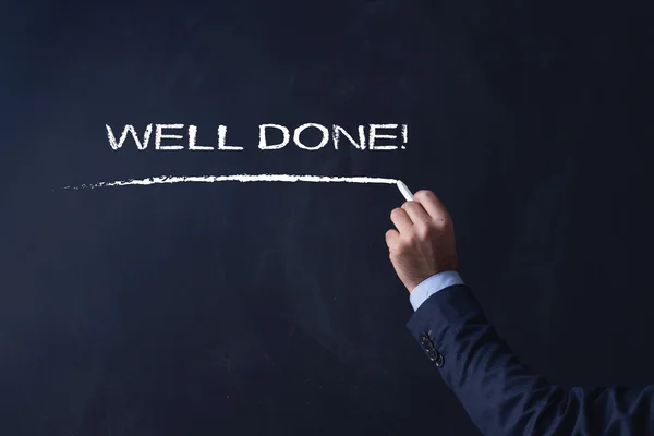 Businessman writing on blackboard — Stock Photo, Image