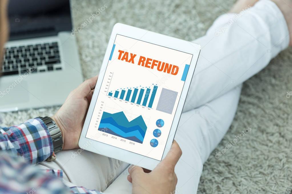 Business Charts and Graphs on screen with TAX REFUND Title