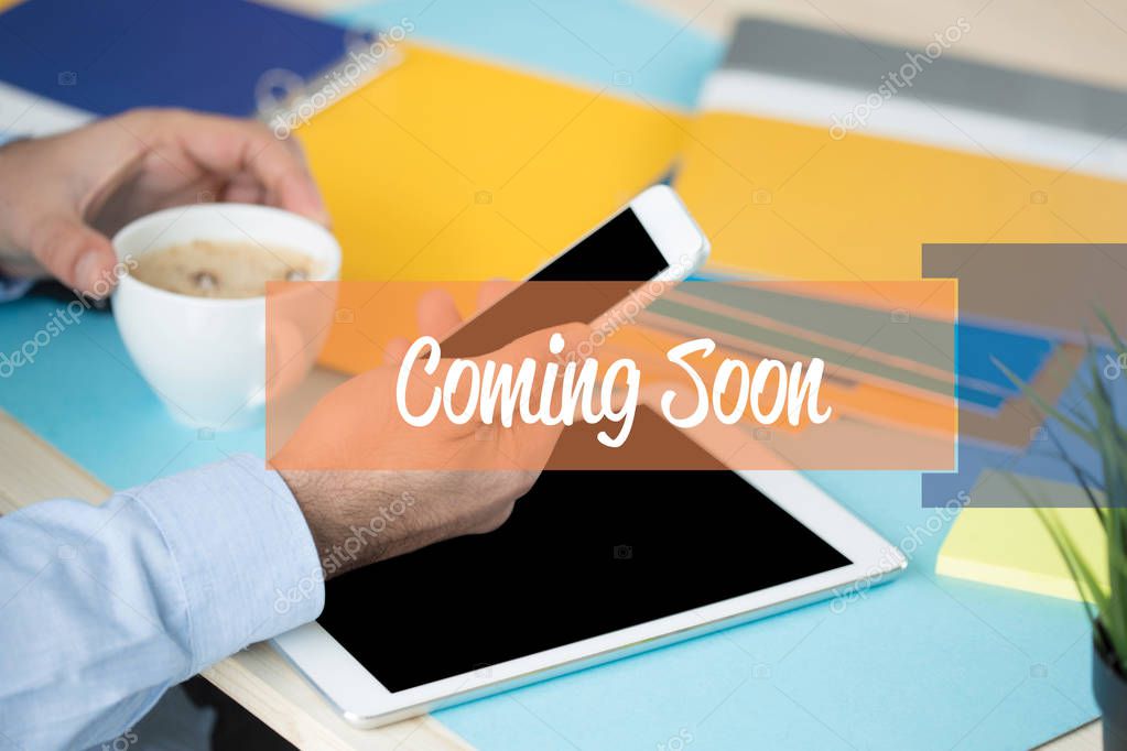 COMING SOON CONCEPT. Businessman using smartphone