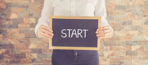 Woman holding board with text — Stock Photo, Image