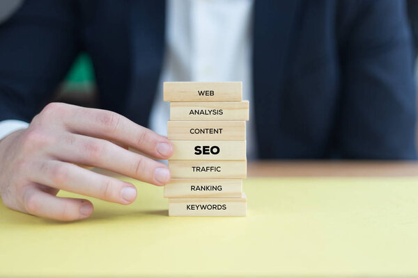 businessman playing with blocks 