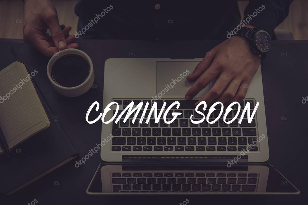 COMING SOON CONCEPT. Businessman using laptop