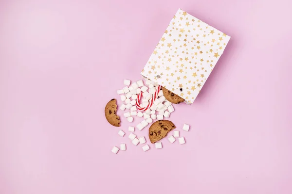 Beyaz Hediye Paketleri Marshmellow ve Tatlı Kurabiyeler ve Şeker Çubuğu Pembe Arkaplan Alışverişi ya da Gıda Tatili Kopya Mekanı